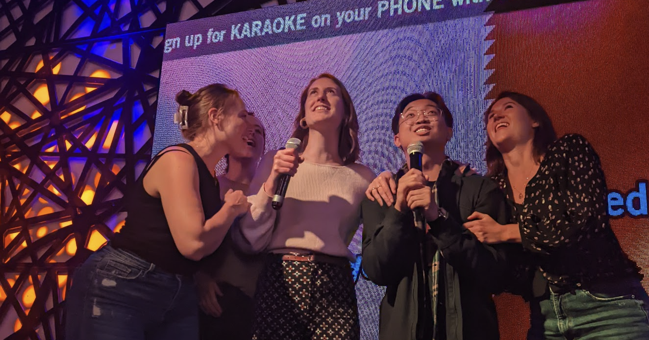 A bunch of friendly, smiling Codeword employees singing their hearts out